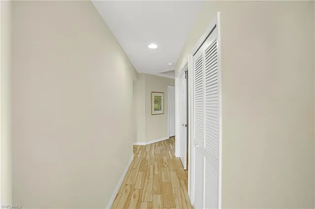 a view of a hallway with wooden floor