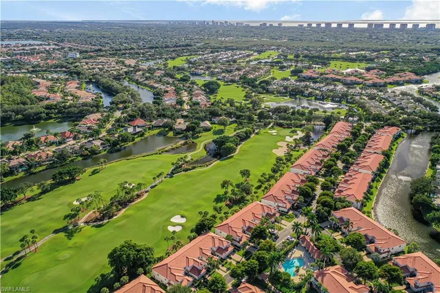 an aerial view of a city with lots of residential buildings and mountain view in back