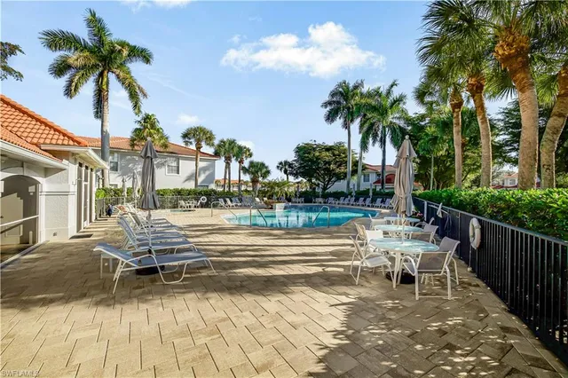 a view of a swimming pool with a patio and a garden