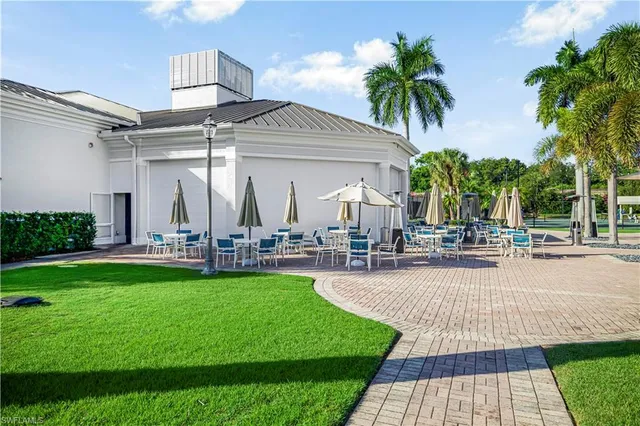a view of a house with a yard patio and swimming pool