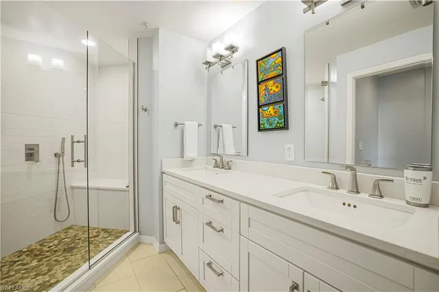 a bathroom with a double vanity sink and a mirror