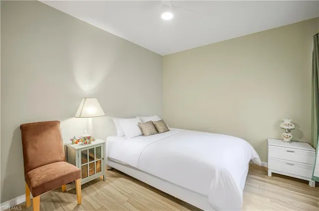 a bedroom with a bed and a chair