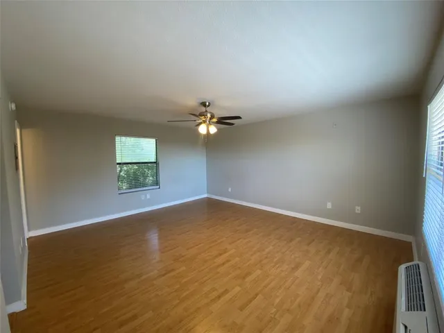 an empty room with a empty space and a ceiling fan