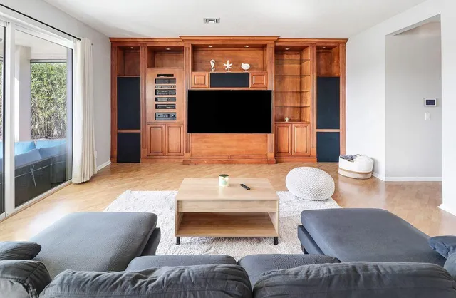 a bathroom with a granite countertop toilet a sink and a mirror