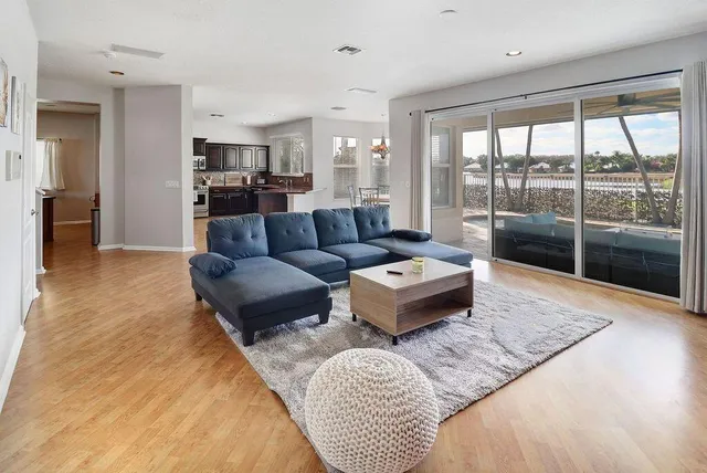 a spacious bedroom with a bed and wooden floor