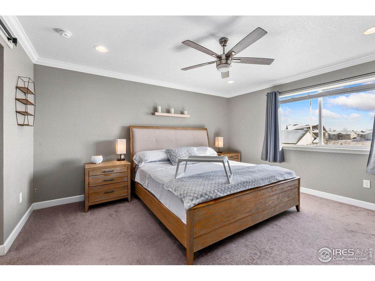 5231 Osbourne Drive Windsor, CO 80550 - Photo 11 of 20 a bedroom with a bed and ceiling fan