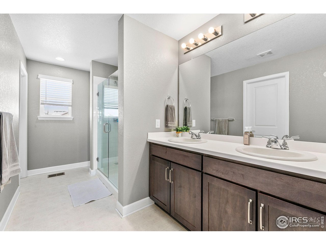 5231 Osbourne Drive Windsor, CO 80550 - Photo 13 of 20 a bathroom with a sink double vanity granite and a mirror