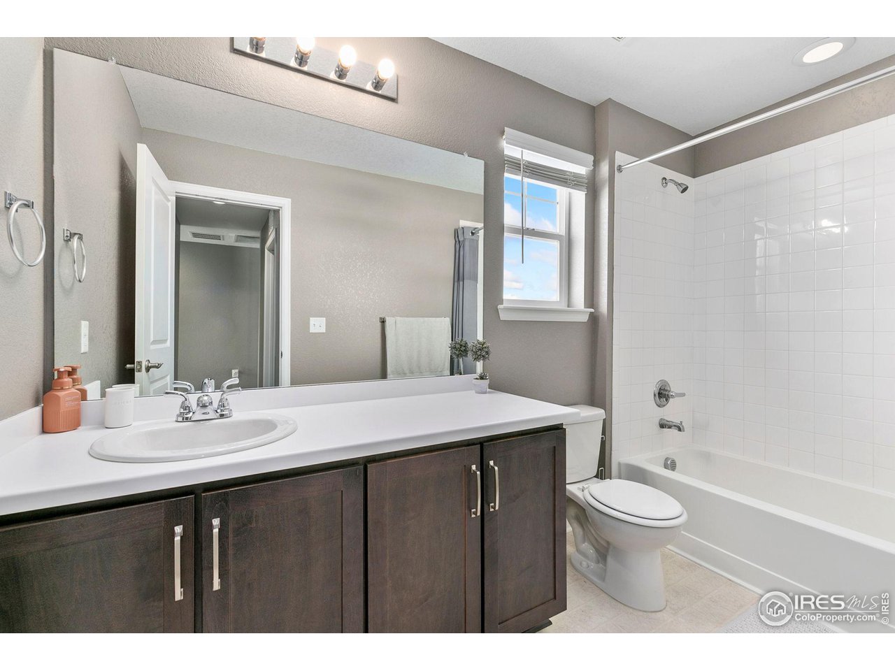 5231 Osbourne Drive Windsor, CO 80550 - Photo 17 of 20 a bathroom with a sink a toilet a mirror and shower