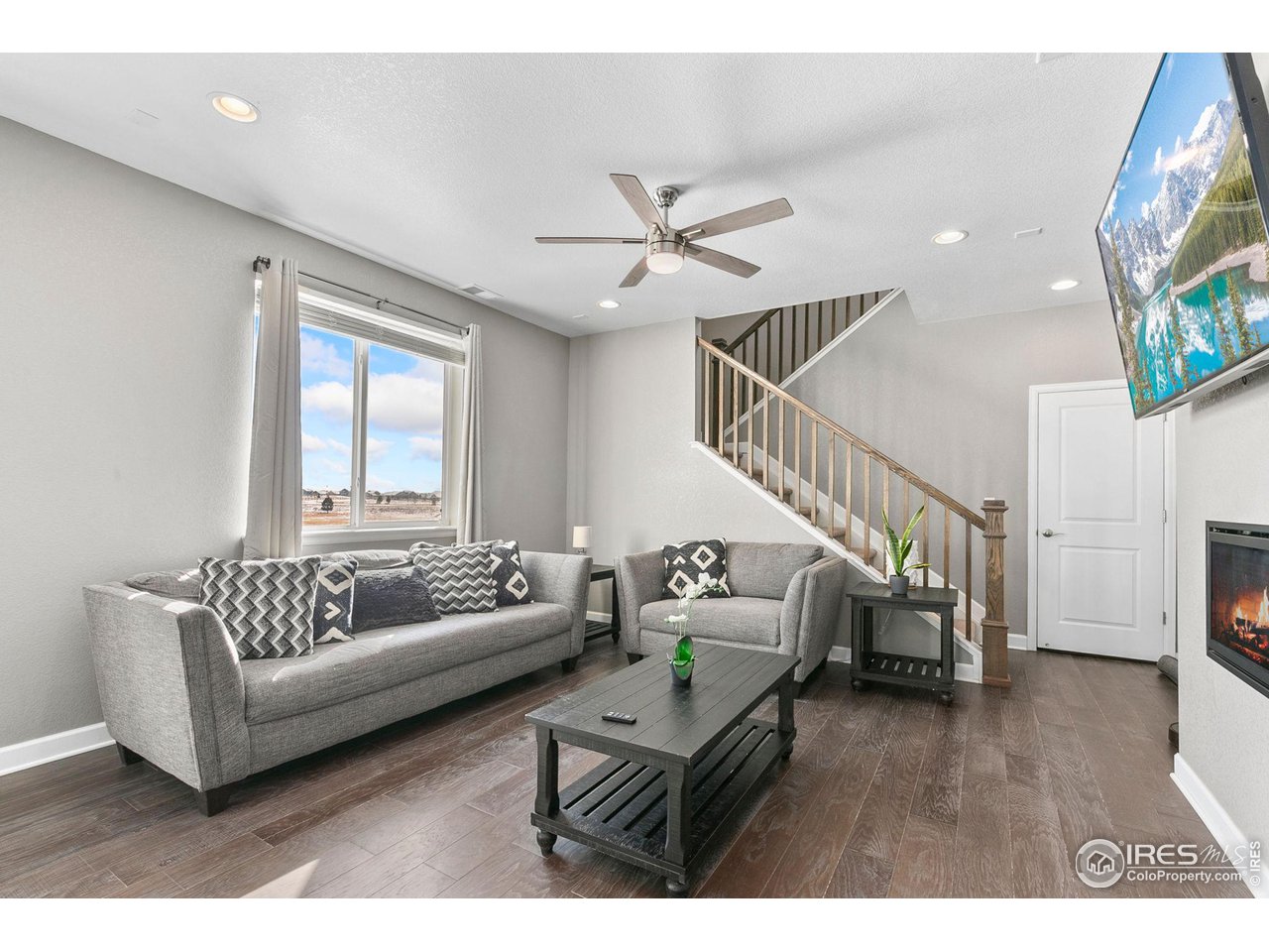 5231 Osbourne Drive Windsor, CO 80550 - Photo 3 of 20 a living room with furniture and a flat screen tv