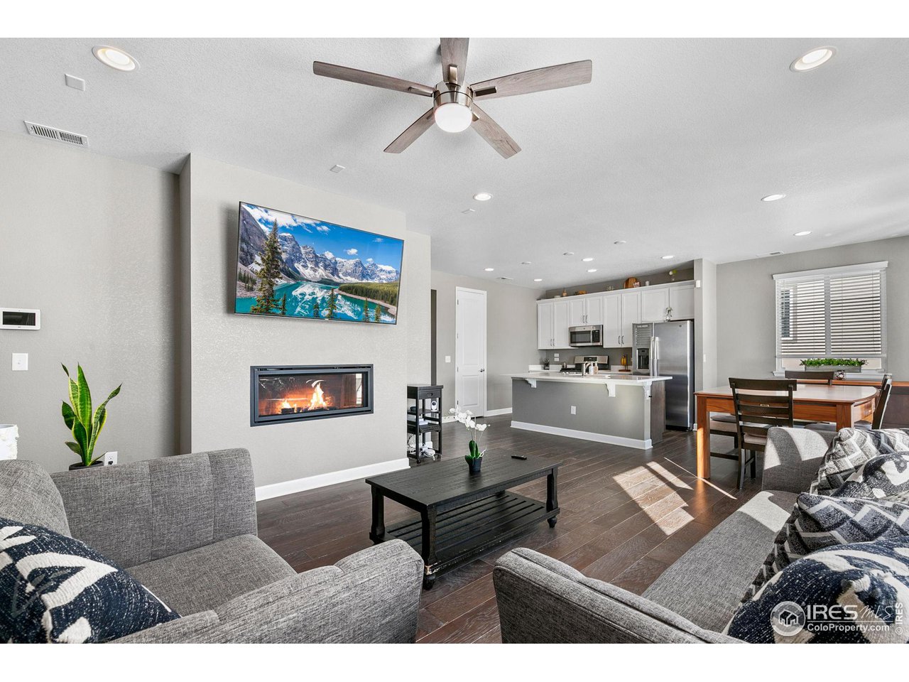 5231 Osbourne Drive Windsor, CO 80550 - Photo 4 of 20 a living room with furniture a flat screen tv and a fireplace