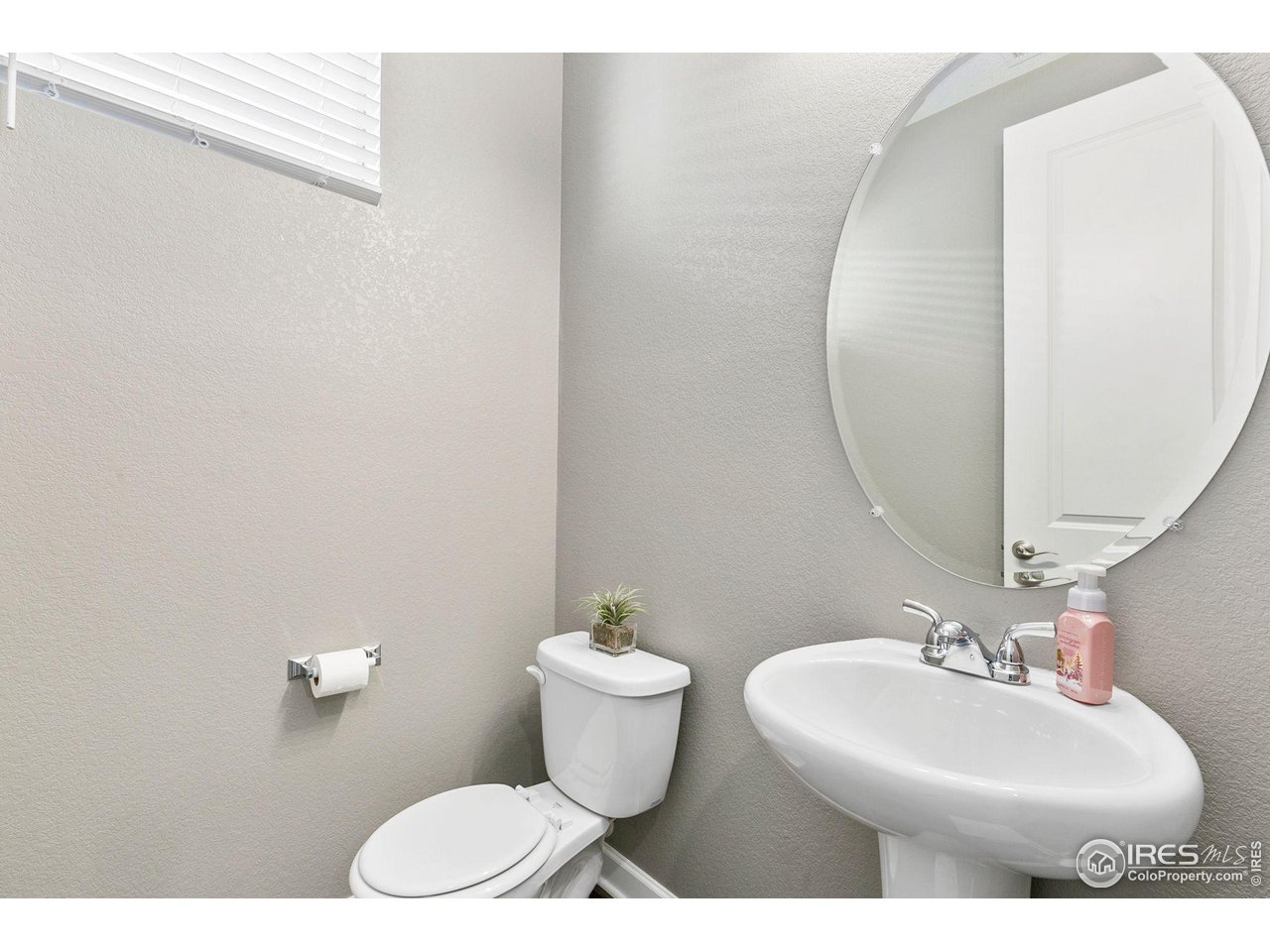 5231 Osbourne Drive Windsor, CO 80550 - Photo 10 of 20 a bathroom with a sink mirror and toilet