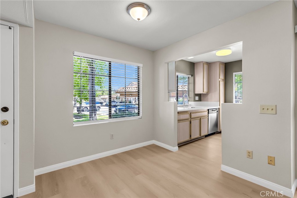 10668 Dabney Drive, Unit 125 San Diego, CA 92126 - Photo 11 of 27 a view of a kitchen with a sink a stove top oven and window
