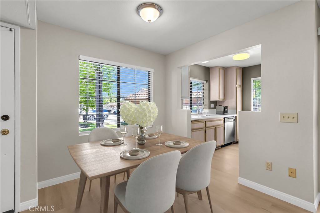 10668 Dabney Drive, Unit 125 San Diego, CA 92126 - Photo 12 of 27 a view of a dining room with furniture and wooden floor