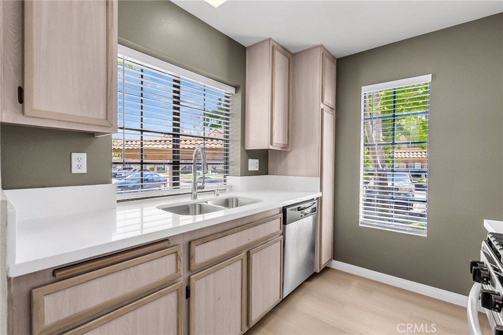 10668 Dabney Drive, Unit 125 San Diego, CA 92126 - Photo 13 of 27 a kitchen with a sink and cabinets