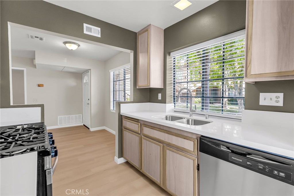 10668 Dabney Drive, Unit 125 San Diego, CA 92126 - Photo 15 of 27 a kitchen with a sink and a stove
