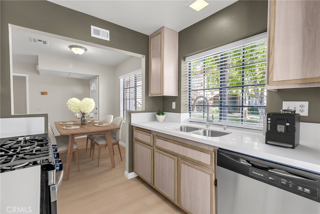 10668 Dabney Drive, Unit 125 San Diego, CA 92126 - Photo 16 of 27 a kitchen with a sink and stove