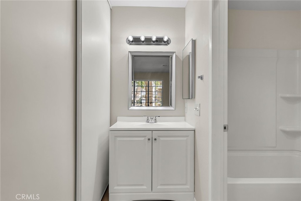 10668 Dabney Drive, Unit 125 San Diego, CA 92126 - Photo 20 of 27 a bathroom with a sink and a mirror