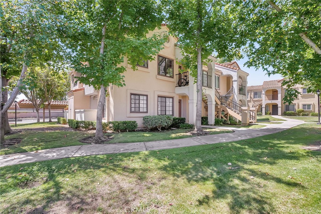 10668 Dabney Drive, Unit 125 San Diego, CA 92126 - Photo 2 of 27 a front view of a house with a yard