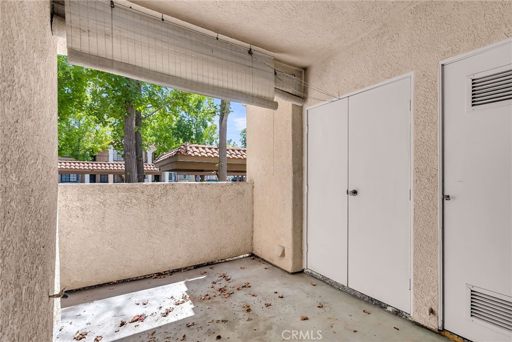 10668 Dabney Drive, Unit 125 San Diego, CA 92126 - Photo 22 of 27 a view of a room with a large window and wooden floor