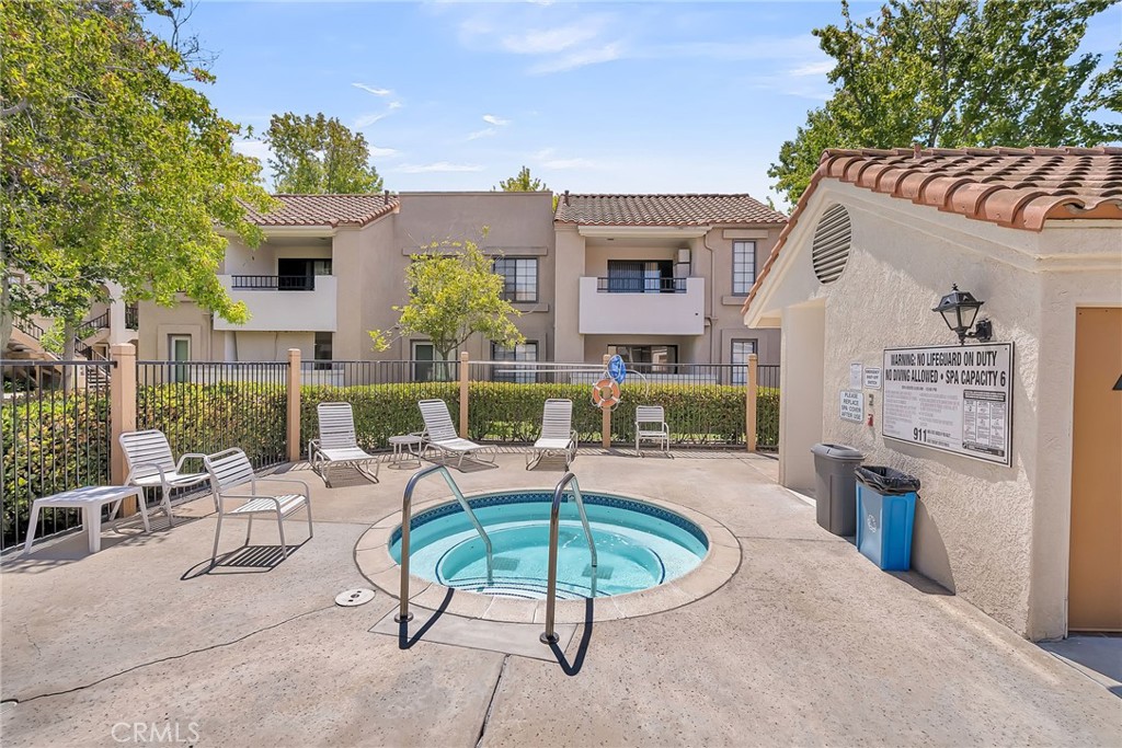 10668 Dabney Drive, Unit 125 San Diego, CA 92126 - Photo 24 of 27 a view of a patio with couches table and chairs with potted plants and a barbeque