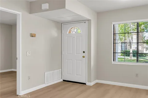 an empty room with windows and closet