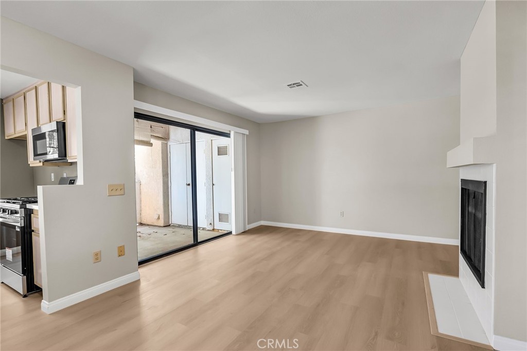 10668 Dabney Drive, Unit 125 San Diego, CA 92126 - Photo 7 of 27 an empty room with windows