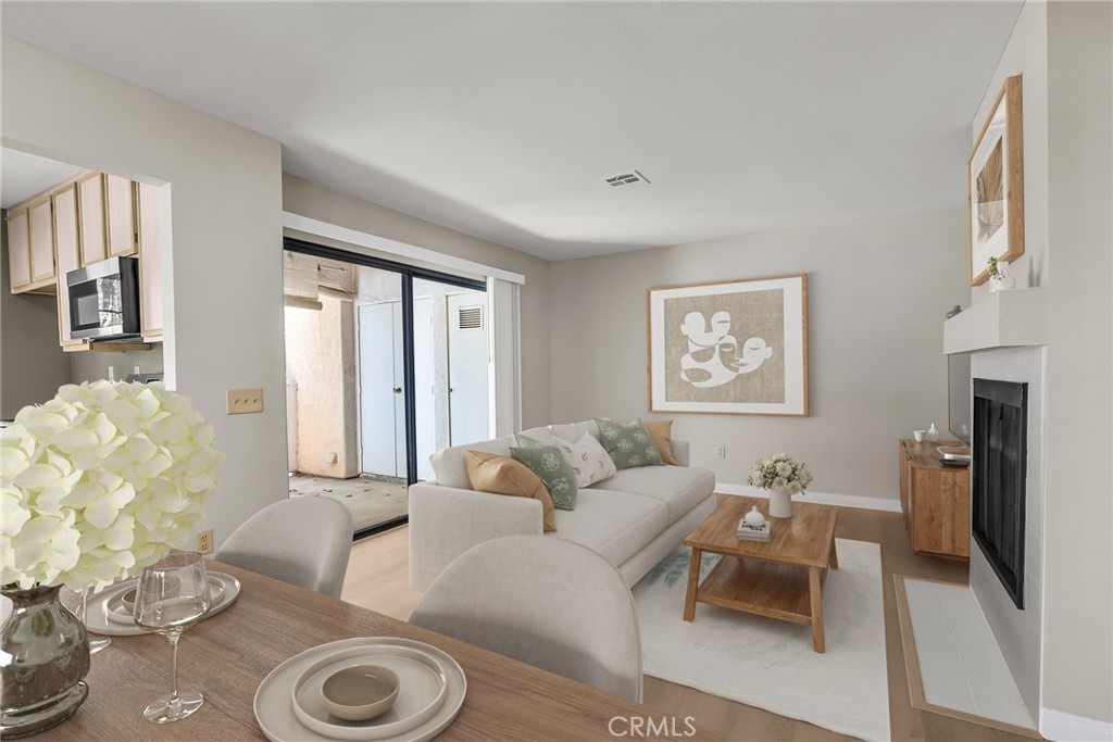 10668 Dabney Drive, Unit 125 San Diego, CA 92126 - Photo 8 of 27 a living room with furniture a fireplace and a table