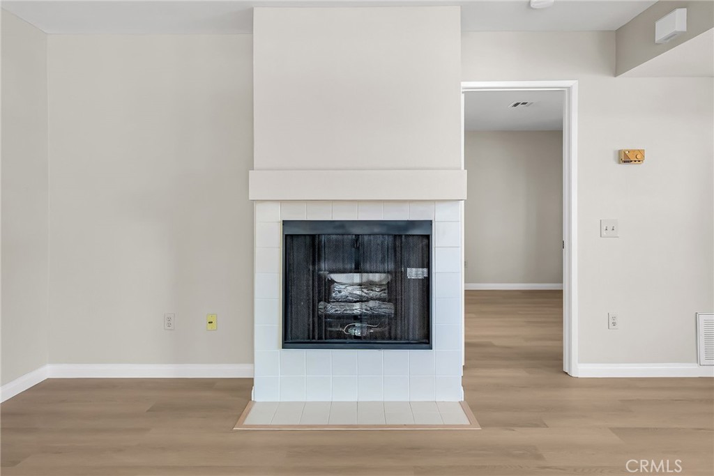 10668 Dabney Drive, Unit 125 San Diego, CA 92126 - Photo 10 of 27 a living room with furniture and a fireplace