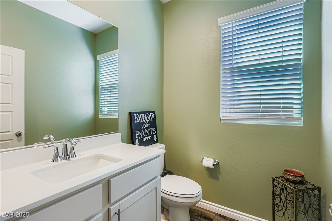 314 Robson Rdg Lane Henderson, NV 89015 - Photo 20 of 64 Half bathroom featuring vanity and dark wood finished floors