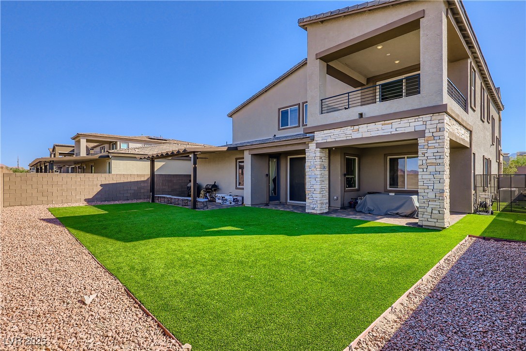 314 Robson Rdg Lane Henderson, NV 89015 - Photo 50 of 64 Back of house featuring stucco siding, a fenced backyard, a patio, and a balcony