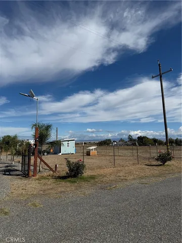 a view of a big yard with table and chairs