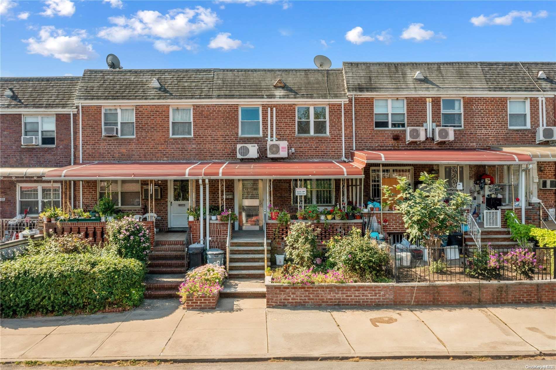 148-08 58th Road Queens, NY 11355 - Photo 1 of 1 a front view of a building with garden