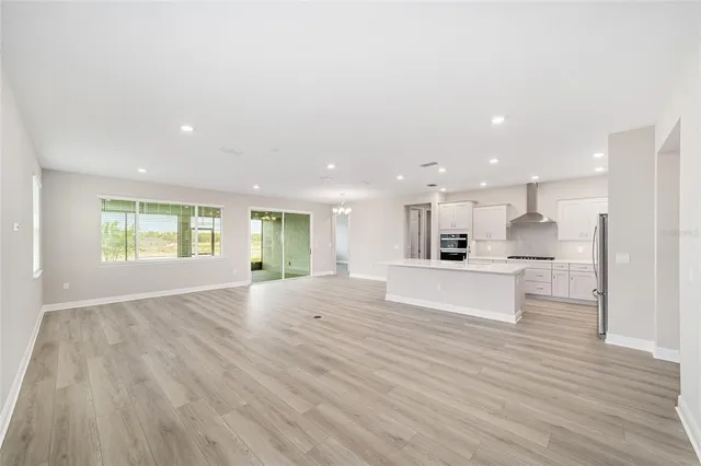 a view of kitchen with kitchen island sink and living room