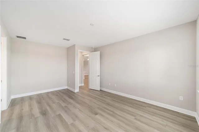 wooden bathroom with a granite countertop sink and a mirror