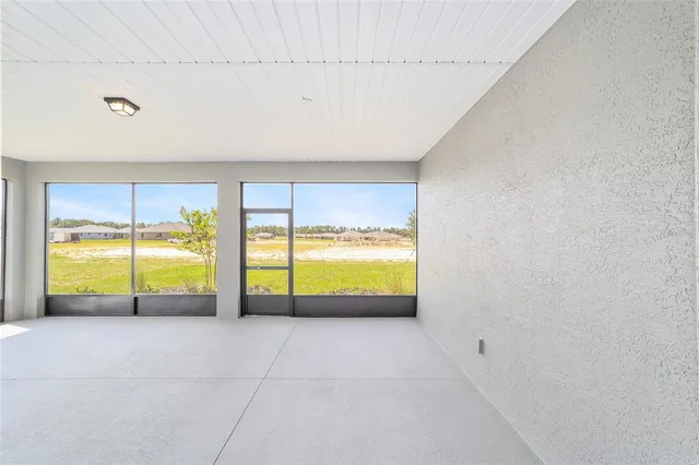 a view of an empty room with a ocean view
