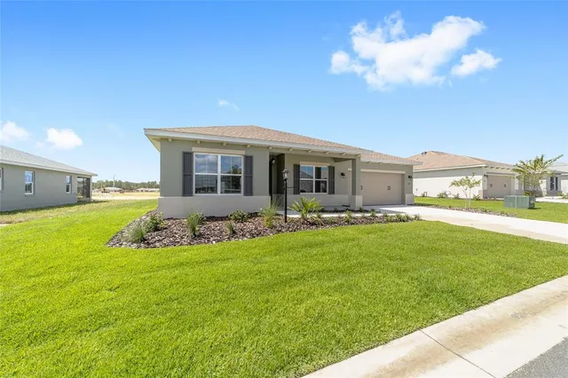 a view of a house with backyard sitting area and garden