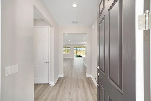 a view of a hallway with wooden floor