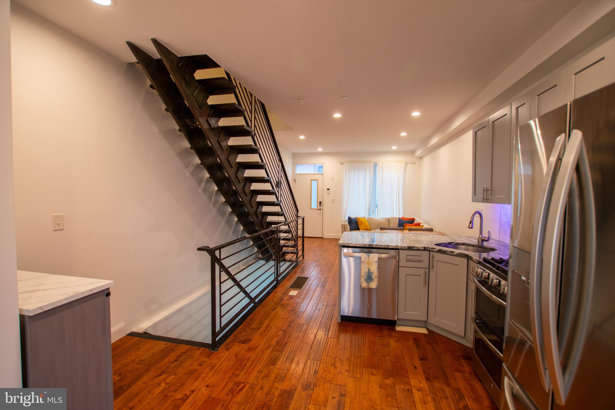 1910 Fernon Street Philadelphia, PA 19145 - Photo 11 of 44 a kitchen with sink a refrigerator and wooden floor