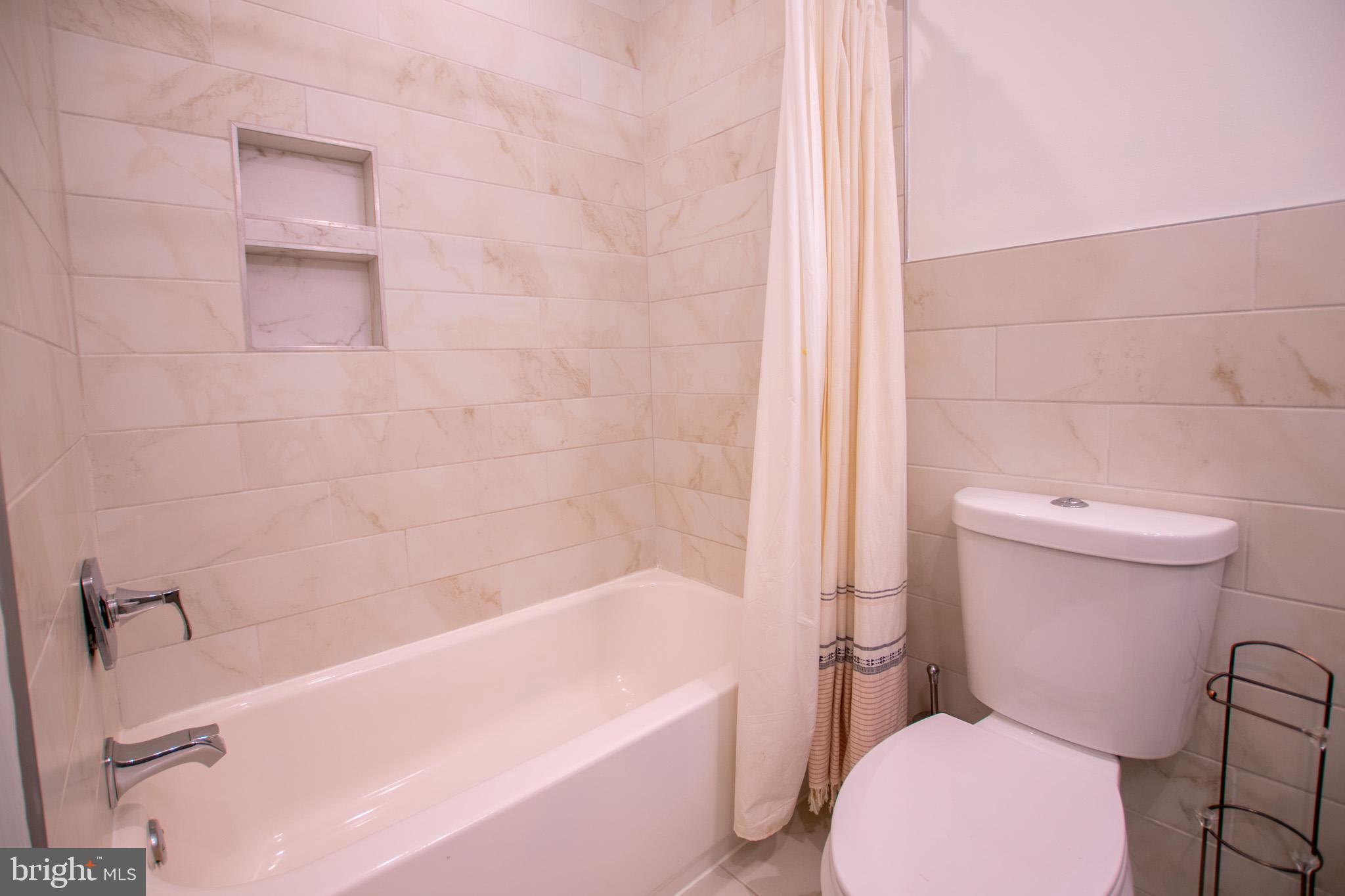 1910 Fernon Street Philadelphia, PA 19145 - Photo 22 of 44 a bathroom with a toilet and a bathtub
