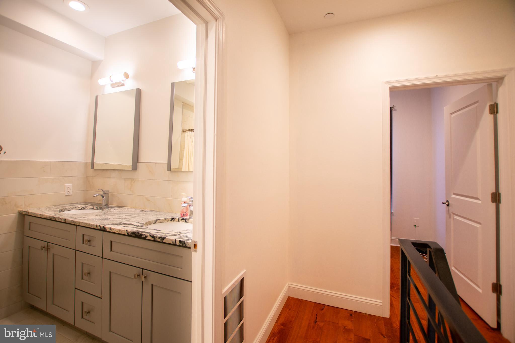 1910 Fernon Street Philadelphia, PA 19145 - Photo 23 of 44 a bathroom with a sink and a mirror