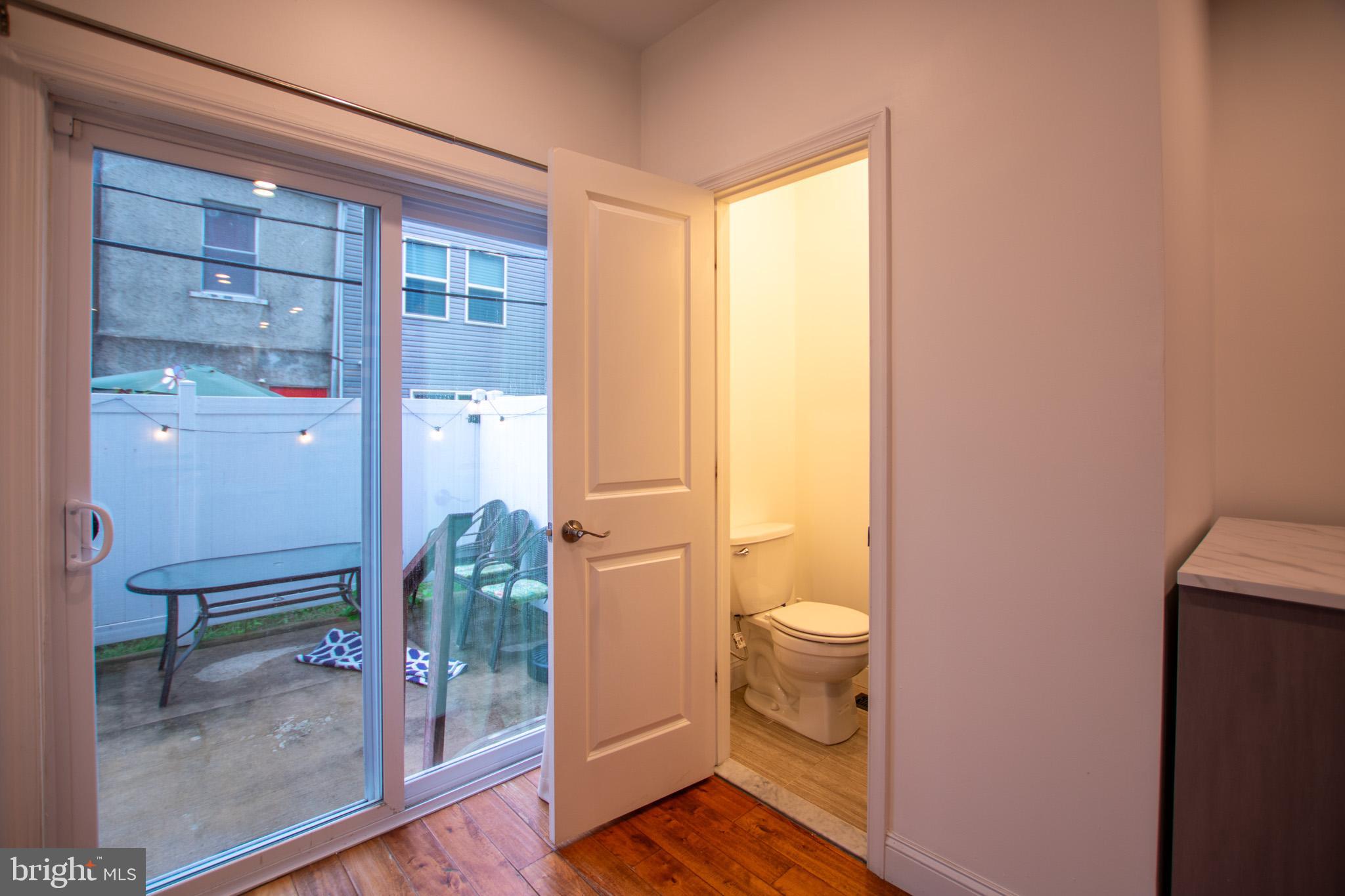 1910 Fernon Street Philadelphia, PA 19145 - Photo 10 of 44 a bathroom with a granite countertop shower a toilet and a sink