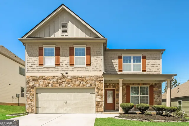 a front view of a house with garden