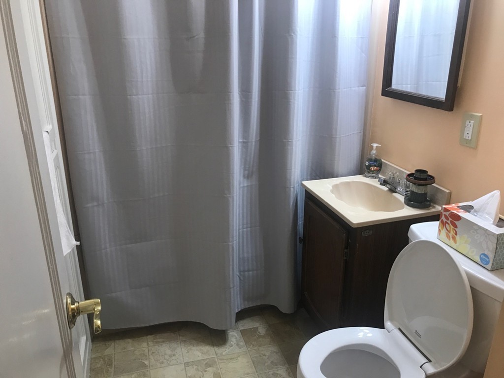 133 Russell Street Springfield, MA 01104 - Photo 15 of 15 a bathroom with a sink toilet and mirror