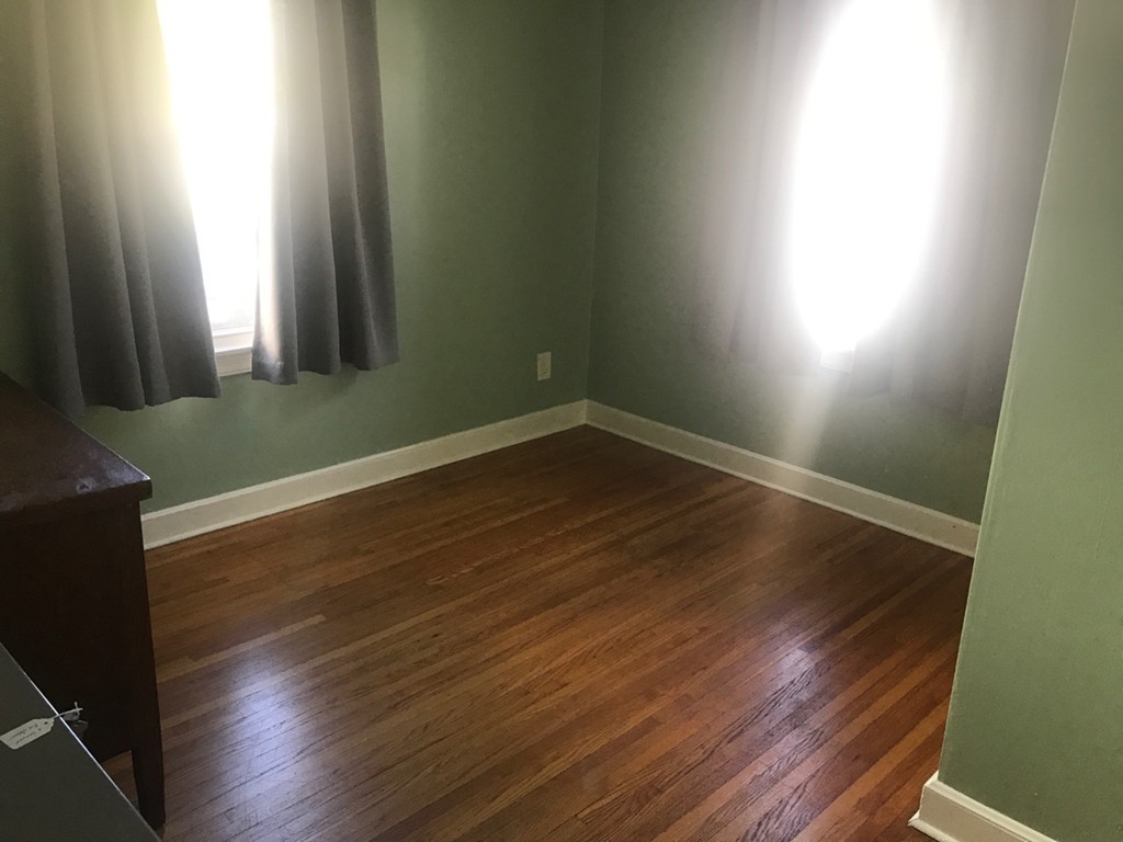 133 Russell Street Springfield, MA 01104 - Photo 7 of 15 an empty room with wooden floor and windows