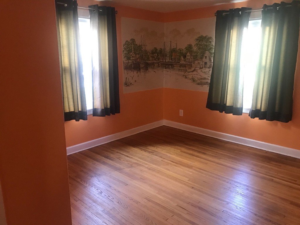 133 Russell Street Springfield, MA 01104 - Photo 9 of 15 an empty room with wooden floor and windows