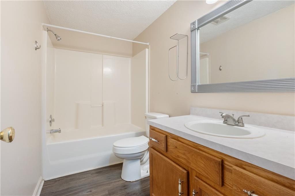 5498 Woodlin Road Lula, GA 30554 - Photo 18 of 40 a bathroom with a sink a toilet and shower