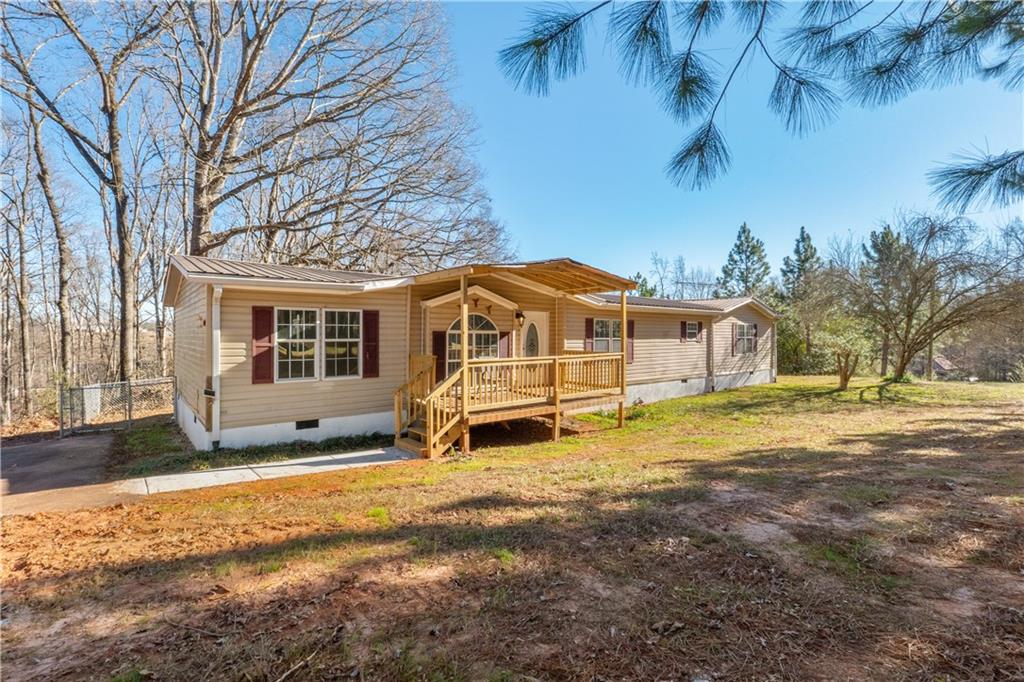 5498 Woodlin Road Lula, GA 30554 - Photo 2 of 40 a front view of a house with a yard