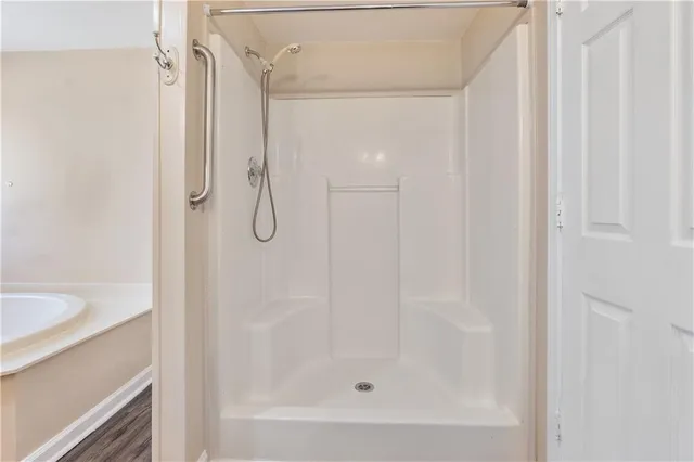 a bathroom with a glass shower door