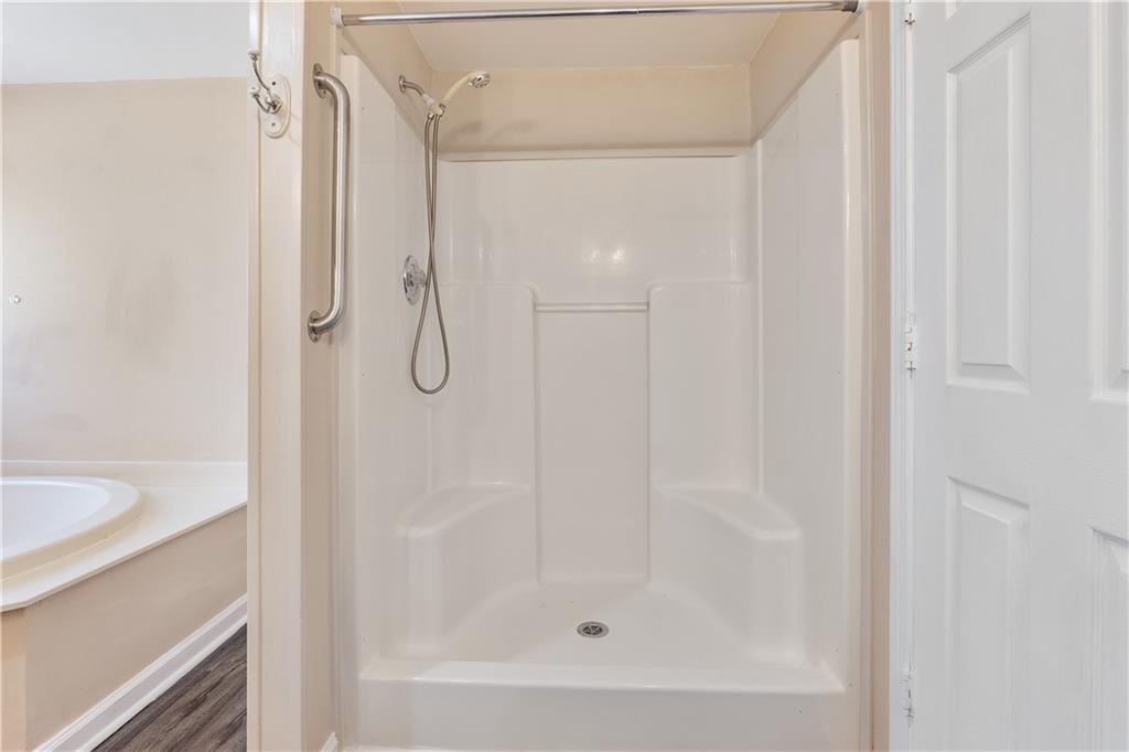 5498 Woodlin Road Lula, GA 30554 - Photo 23 of 40 a bathroom with a glass shower door