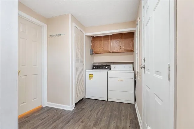 a view of walk in closet with wooden floor